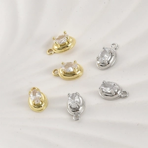 Detail of 14k gold and silver plated oval zircon pendants for DIY jewelry making