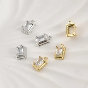 Macro shot of 14k gold and silver plated rectangular zircon pendants for DIY jewelry