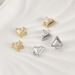 Macro detail of triangle 14k gold plated zirconia pendants for DIY jewelry making