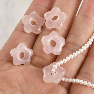 Detail of pink crystal flower beads on hand showing size and necklace DIY usage