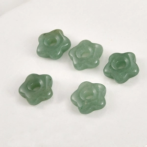 Macro shot of 5pcs flower-shaped green aventurine stone beads for DIY jewelry making