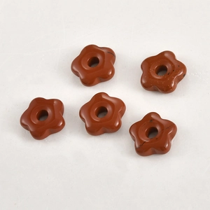 Detailed view of red jasper natural stone flower beads with center holes for DIY jewelry