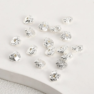 Detailed view of silver irregular lava texture beads for DIY jewelry making