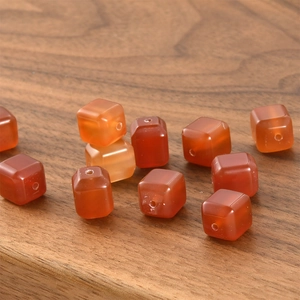 Macro detail of cube-shaped red agate beads with a polished finish for DIY jewelry making