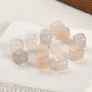 Macro shot of cubic pink agate spacer beads with holes for DIY jewelry making