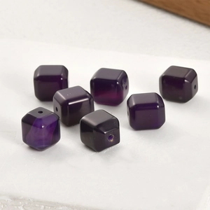 Macro shot of seven purple cube crystal beads with soft luster for DIY jewelry making