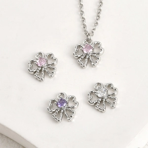 Macro shot of 14k gold plated bow pendants with zircon stones for DIY jewelry making