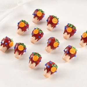 Handmade lampwork glass mushroom berry beads for DIY jewelry making scattered on white