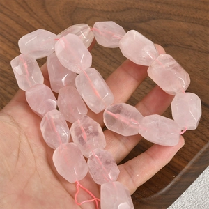 Macro view of faceted long barrel rose quartz beads with natural crystal texture