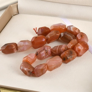 Faceted natural red agate stones showing unique textures and high glass luster