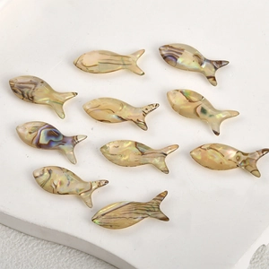 Macro shot of 10-piece fish-shaped iridescent natural shell pendants for DIY jewelry