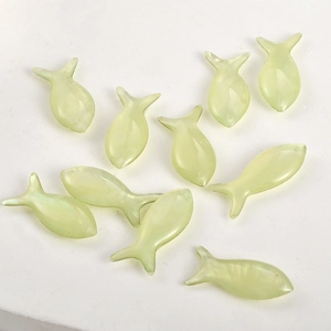 Macro view of translucent fish-shaped resin charms with holes for jewelry DIY making