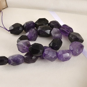 Macro shot of faceted raw amethyst and black obsidian stones for DIY jewelry making