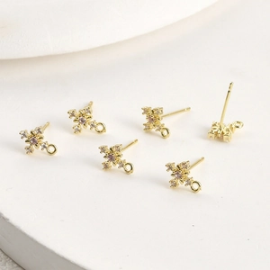 Close-up of 14k gold plated cross stud earrings with zircon for DIY jewelry making