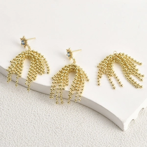 Set orecchini e pendente a nappa dorata con stelle di zircone blu scintillante