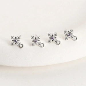 Macro detail of snowflake zircon charms with purple stone for DIY jewelry making