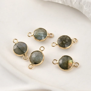 Detailed view of five round faceted labradorite stone connectors with gold plated edges