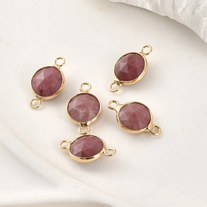 Detailed macro view of 5 rose-hued faceted crystal connectors with gold plated edges