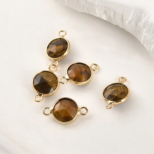 Macro shot of tiger eye stone pendants with gold plated edges for jewelry making