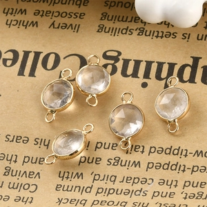 Macro shot of faceted crystal charms with gold-plated edges and double jump rings