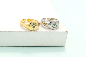 Polished gold and silver signet rings with black paw prints and zircon accents