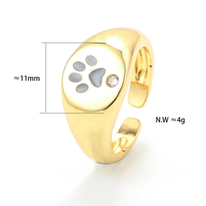 Detail of adjustable golden ring with grey paw print pattern and small zircon stone