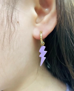 Pendientes de rayo violeta con aros dorados de moda lucidos por una modelo real