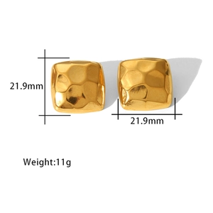 Macro detail of 18K gold-plated geometric square stud earrings with hammered texture