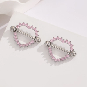 18K gold plated stainless steel heart nipple rings with pink zircon inlays on white stand
