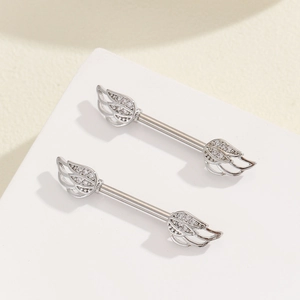 Surgical steel nipple rings featuring silver angel wing designs with sparkling crystals