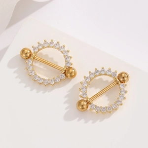 Close-up of 18K gold-plated nipple rings with radiating zircon stones on stone stand