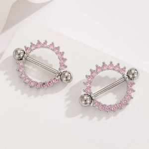 Macro detail of round 18K gold plated nipple ring with sparkling pink zirconia accents
