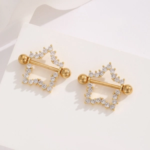 Macro view of gold stainless steel nipple rings with star-shaped cubic zirconia detail