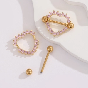 Detail of gold heart nipple ring showing disassembled bar, ball and pink zircon