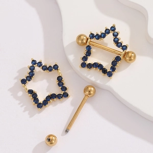 Detailed view of disassembled gold nipple ring with blue star zircon shield and threaded bar