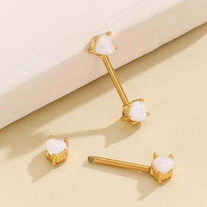 Detail of 18K gold stainless steel nipple rings with heart-shaped white fire opals