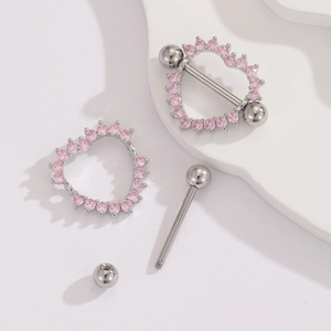 Macro shot of stainless steel heart nipple rings with pink zircon inlays and threaded bar