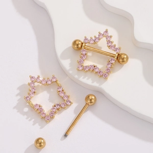 Detailed view of star-shaped nipple piercing with pink zircons on a white stone base