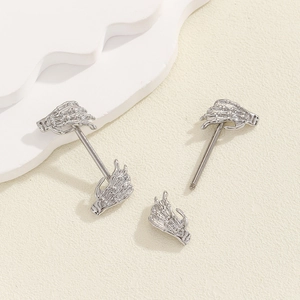 Detail of silver skull hand nipple ring with threaded bar on white background