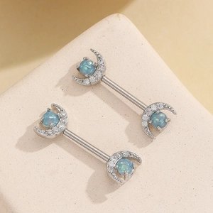 Macro shot of silver crescent moon nipple ring with blue opal and white zircon stones