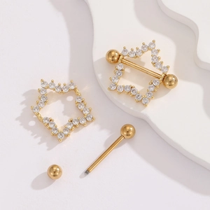 Detail of 18K gold star nipple shield with cubic zirconia and barbell components