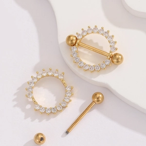 Macro shot of 18K gold nipple ring with clear zircon stones and barbell structure