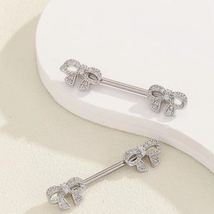 Detail view of silver nipple rings with sparkling bowknot zircon stone inlay