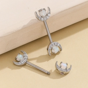 Detail of moon-shaped nipple rings with white opal and clear zircons in silver finish