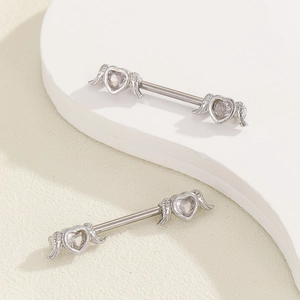 Detail of silver heart wing nipple rings with sparkling zircon inlay and polished finish