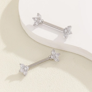 Detail of silver nipple bars featuring sparkling clover-shaped zircon stones