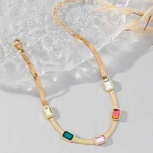 Flat gold snake chain bracelet with five rectangular colored zircons and lobster clasp