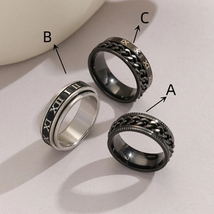 Three vintage stainless steel spinner rings with Roman numerals and chain textures