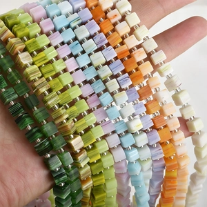 Close-up of colorful square sugar-shaped glass beads with natural marble texture for DIY