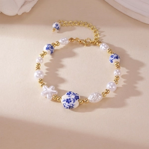 Detail of blue and white porcelain heart beads and pearls on a retro Chinese style bracelet